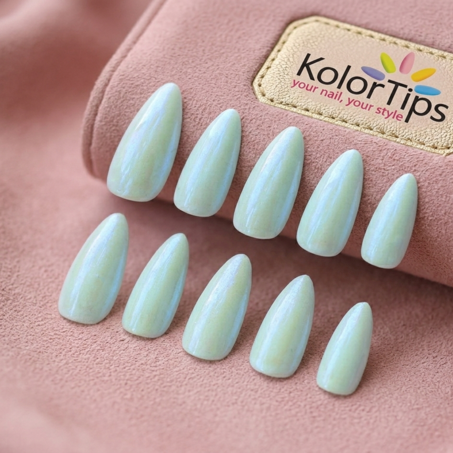 Light green nail tips with KolorTips logo on a pink background